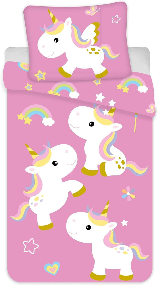 Parure de lit bébé rose avec licornes et arcs-en-ciel sur lit à barreaux