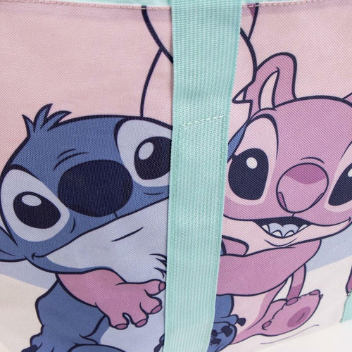 Vue rapprochée des anses du sac Stitch montrant le port à l’épaule