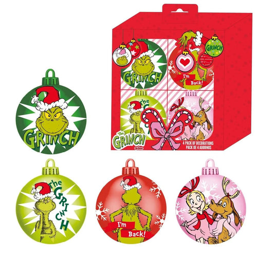 Décoration Grinch rouge miniature posée sur fond de sapin de Noël